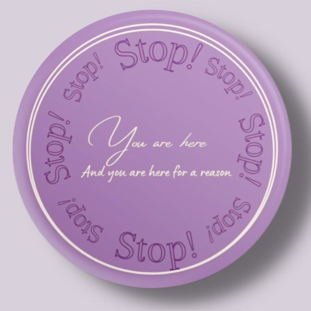 Purple pin back button that reads 'you are. here for a reason'